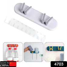 Plastic bathroom organizer, wall-mounted with shelf and hooks for accessories.